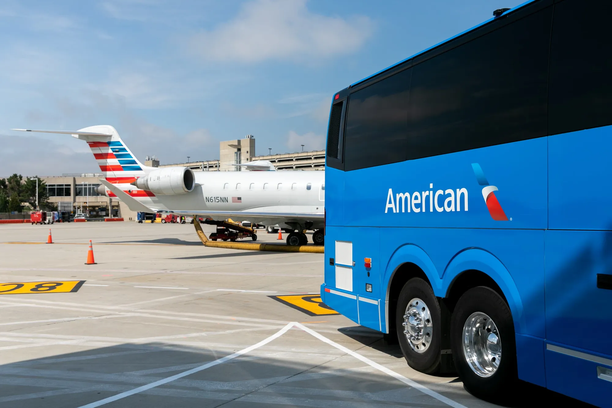 A Landline motorcoach parked at an airport gate