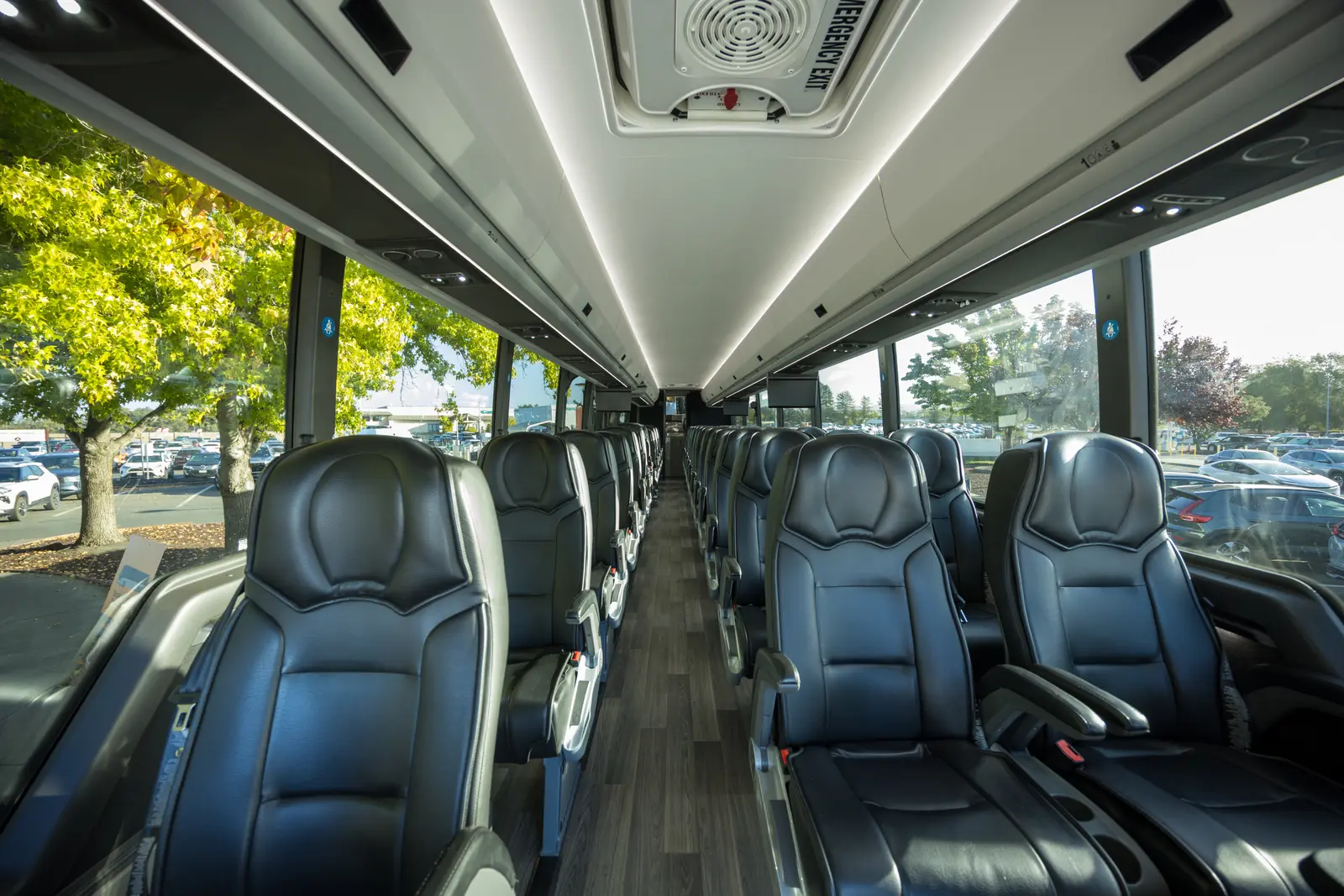 Rows of black leather seats inside a Landline coach.
