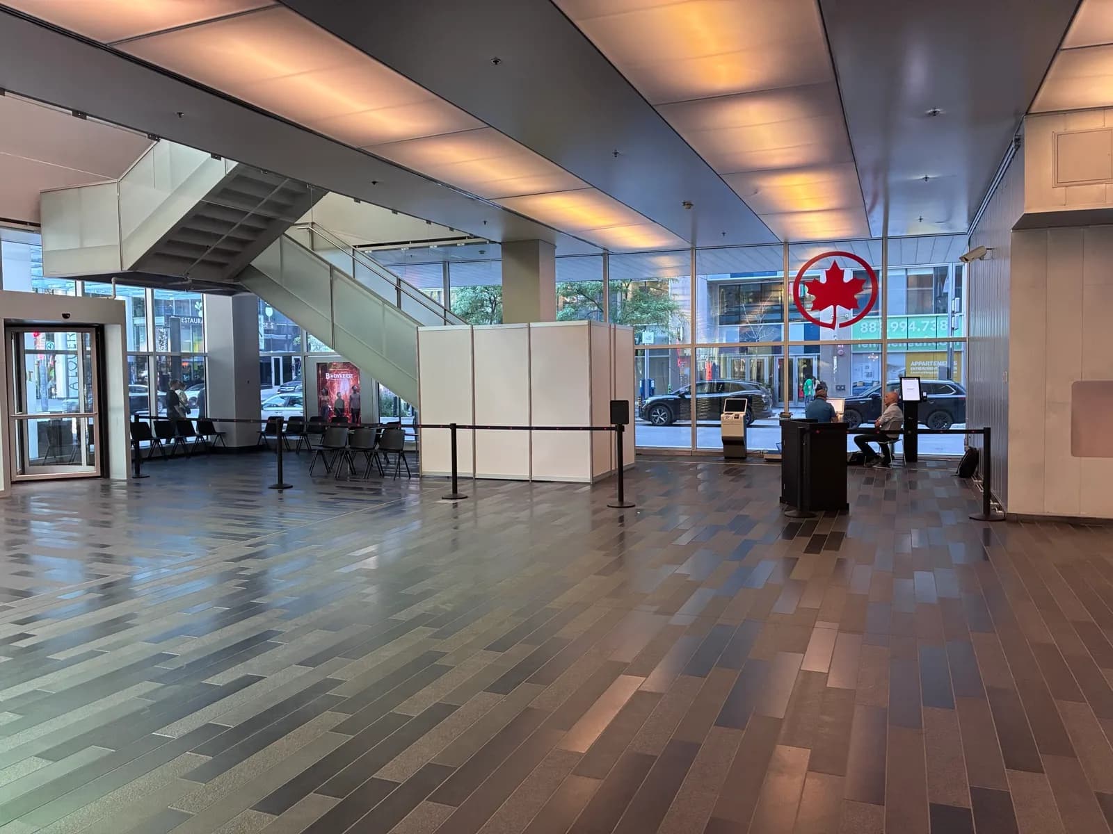 The Landline waiting area inside the Palais des congrès main entrance, with the Air Canada service desk and a ticket kiosk.